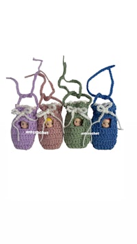 a group of crocheted baby dolls in different colors