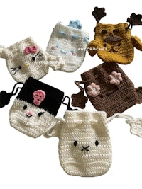 a group of crocheted kawaii pouches on a white background