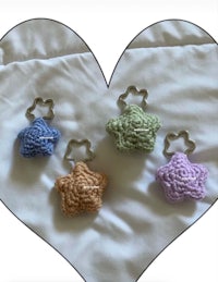 four crocheted stars in a heart shape